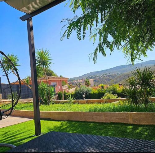 a view of a garden from the patio of a house at Buen Estar, piscina, barbacoa, jacuzzi en Valencia in Turís
