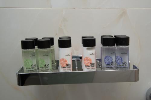a shelf with a bunch of hair products on it at Serenity by Elite Dwellings in Portariá