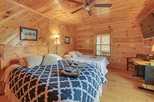 a bedroom with two beds in a log cabin at Pet-Friendly Cabin with Hot Tub in Daniel Boone NF in Beattyville