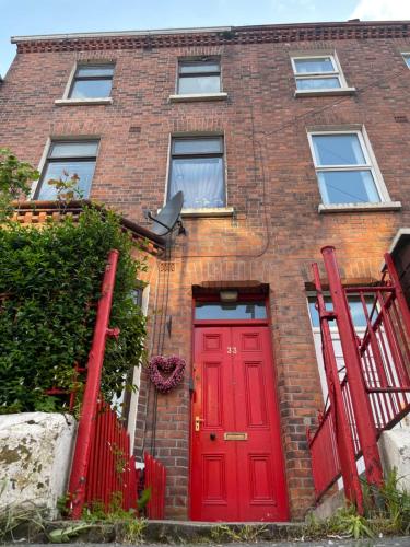 a red brick house with a red door at House in Antrim road in Belfast