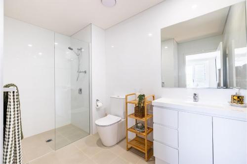 a bathroom with a toilet and a sink and a shower at The Shoal, 508, Bullecourt St - stunning views, air con, lift and Wi-Fi in Shoal Bay