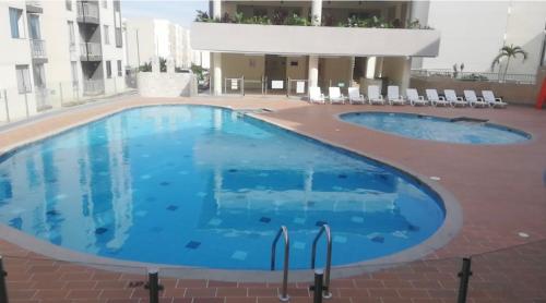 a large swimming pool in the middle of a building at Apartahotel in Ibagué