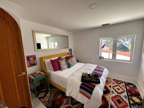 a bedroom with a bed and a window at Private Hacienda with Heated Pool and Spa with Amazing Views in Del Mar
