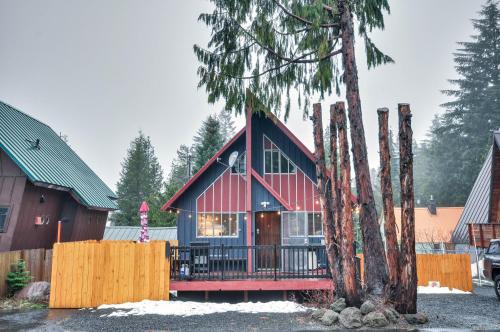 a house with a red roof and a tree at Inviting Mt Hood Cabin with Porch 1 Mi to Skibowl! in Government Camp