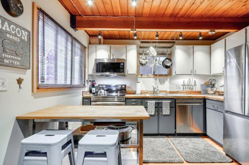 a kitchen with a wooden table and stools in it at Inviting Mt Hood Cabin with Porch 1 Mi to Skibowl! in Government Camp