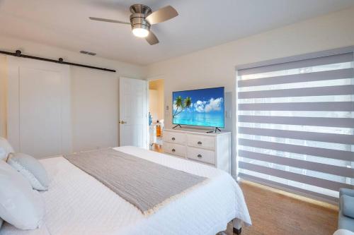 a bedroom with a bed and a flat screen tv at Condo in Naples Near Mercato and Close to Vanderbilt Beach in Naples