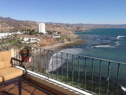a balcony with a chair and a view of the ocean at Oceanfront luxury condo K38 Club Marena in Rosarito