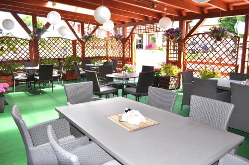 a table and chairs in a restaurant with tables and chairs at Aparthotel Mikołajki in Mikołajki