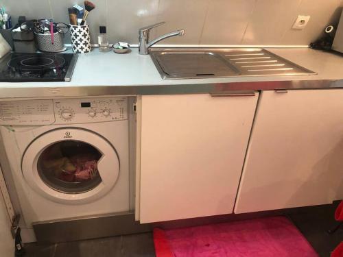 une cuisine avec un évier et une machine à laver dans l'établissement STUDIO CŒUR VIEUX PARIS. Pied du métro.Tout équipé, à Paris