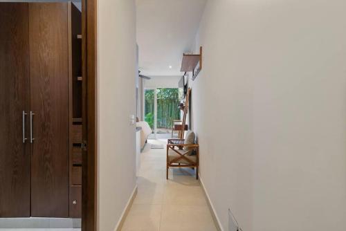 a hallway leading to a living room with white walls at Marina Haven Rooftop Jacuzzis Prvt Dock BBQ & Pool in Puerto Aventuras