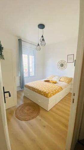 a bedroom with a bed and a wooden floor at Appartement standing Le Havre in Le Havre