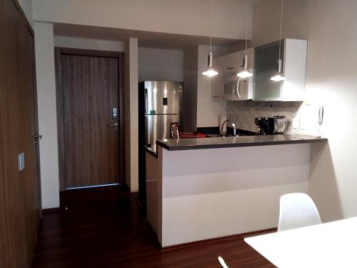 a kitchen with a sink and a refrigerator at Beautiful Apartment Reforma77 22thfloor 1bdr 2bath in Mexico City