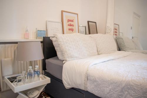a bedroom with a bed and a table with a lamp at SW Stay - Stylish One Bedroom with patio in London
