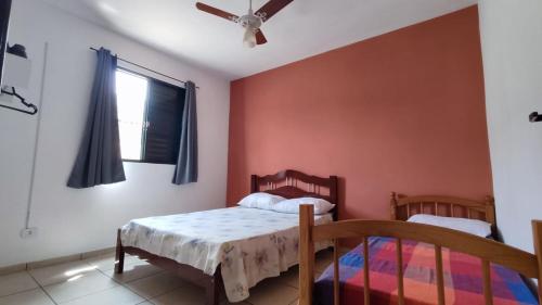 a bedroom with two beds and a ceiling fan at Apê Aconchego I in Águas de São Pedro