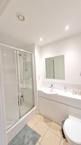 a bathroom with a shower and a toilet and a sink at Contemporary One-Bedroom Apartment in Sheffield City Centre in Sheffield