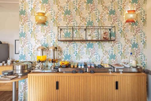 a kitchen with a counter with food on it at Sure Hotel by Best Western Sarlat-la-Canéda in Sarlat-la-Canéda