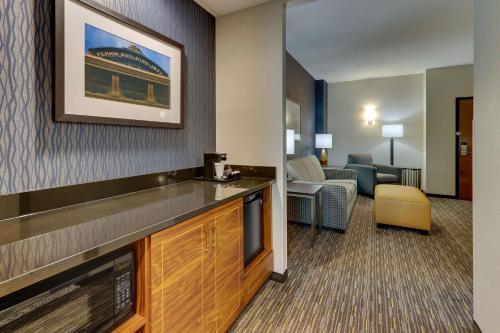 a hotel room with a bar and a living room at Drury Inn & Suites Lafayette IN in Lafayette
