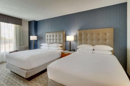 a hotel room with two beds and two lamps at Drury Inn & Suites Lafayette IN in Lafayette