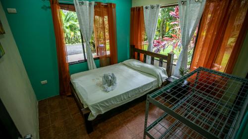 a small bedroom with a bed and a window at Cabañas Río Escondido en La Fortuna in Fortuna
