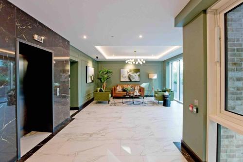 a hallway with green walls and a living room at Westwood Brand new AC Luxury 2bed 2 bathrooms spacious family unit in London