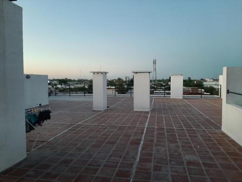 an empty parking lot with white pillars on a roof at Departamento FICO 2 in Sunchales