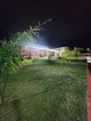 a building with lights in a field at night at El 5to Elemento in La Falda