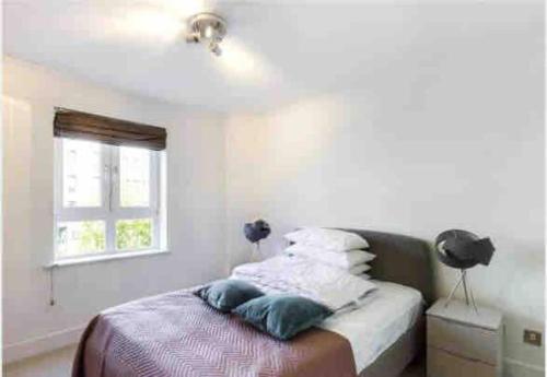 1 dormitorio con cama con almohadas y ventana en Globe View St Pauls London, en Londres