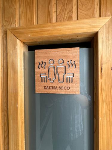 a sign on a glass door of a bathroom at Guemes Hotel & Spa in Salta