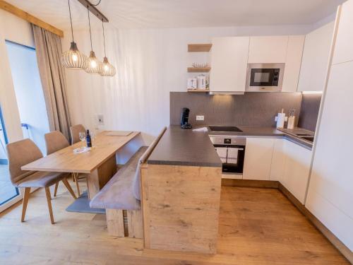 a kitchen with a wooden table and a dining room at Kreischberg The Exclusive 5 in Sankt Lorenzen ob Murau