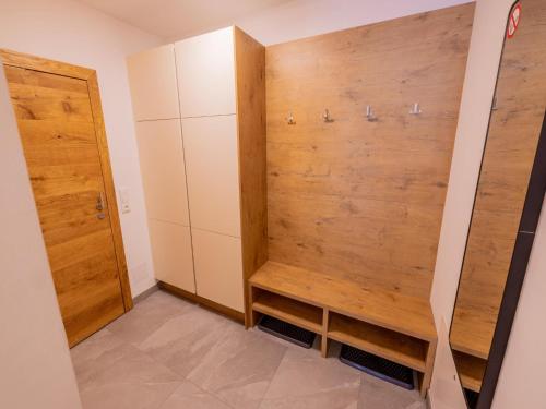 a walk in closet with a wooden wall at Kreischberg The Exclusive 5 in Sankt Lorenzen ob Murau