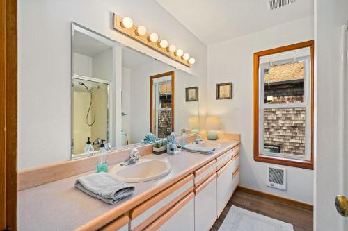a bathroom with a sink and a large mirror at Sand Bucket in Manzanita
