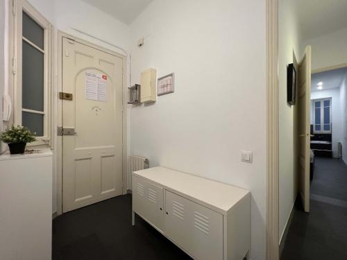 a room with a white door and a bench at Stay Unique Apartments Cent in Barcelona