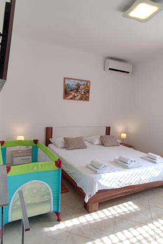 a bedroom with two beds in a room at Family-friendly apartments with swimming pool Vinisce, Trogir - 12676 in Vinišće