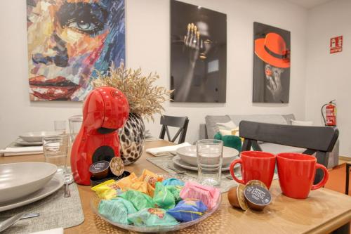 a dining room table with a plate of food on it at Apartamento Lokys centro ciudad, parking privado gratuito in Murcia