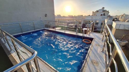 a swimming pool on a cruise ship with the sunset at فندق ستي فيو- City View Hotel in Jeddah