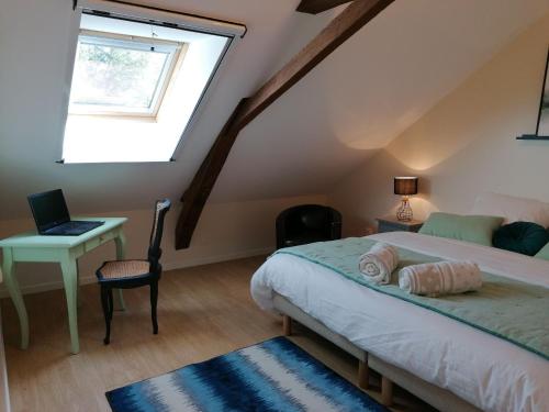 a bedroom with a bed and a desk and a window at Gîte Cossé-le-Vivien, 4 pièces, 6 personnes - FR-1-600-143 in Cossé-le-Vivien