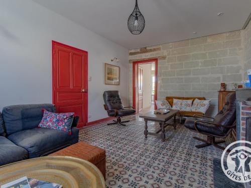 a living room with a blue couch and chairs at Maison Authentique sur 3 Niveaux avec Terrasse et Vue Loire - FR-1-622-38 in Ingrandes
