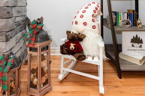 a stuffed teddy bear sitting in a rocking chair at Charming riverside cottage, walk to beach in Wasaga Beach