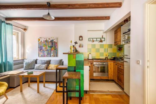a kitchen and living room with a couch and a table at Apartments with WiFi Zagreb - 21954 in Zagreb