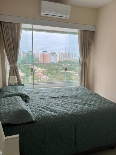 a bedroom with a bed and a large window at Está errado! App ruim in Rio de Janeiro