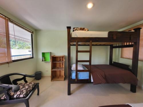 a bedroom with two bunk beds in a room at Hostal Minkalab in Santa Rosa de Cabal