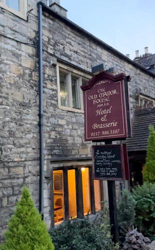a building with a sign in front of a building at The Old Manor House Hotel in Keynsham
