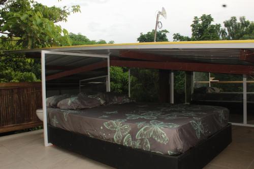 a bed under a canopy on a patio at Glamping Bio Coliving Tayrona in Santa Marta