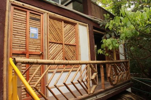 a wooden balcony of a house with a window at Bio Coliving Tayrona in Santa Marta