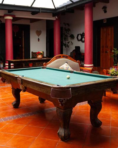 a pool table with a ball on top of it at Hostal Casa Gaia in San Cristóbal de Las Casas