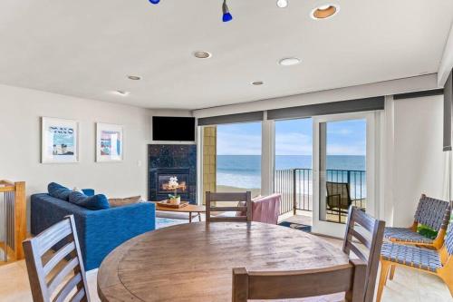 a living room with a table and a blue couch at A Wave From It All in Carlsbad