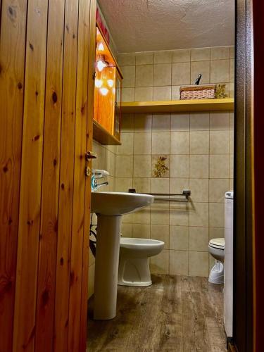 a bathroom with a sink and a toilet at Casa del Lago in Valtournenche