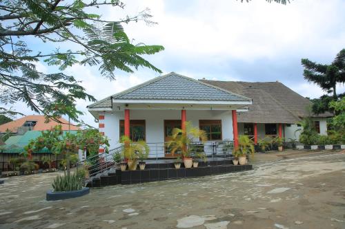 a house with plants in front of it at St. Patrick’s Forest House in Entebbe