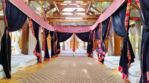 a room with blue and red curtains and a corridor at Vân Hồ Ecolodge in Mộc Châu