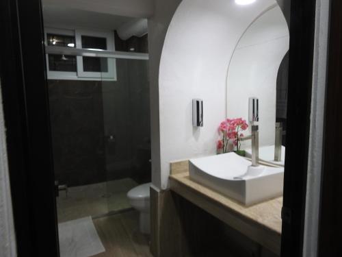 a bathroom with a sink and a toilet at Penthouse Ave Paraiso en Manzanillo 505 Apt 16b in Manzanillo